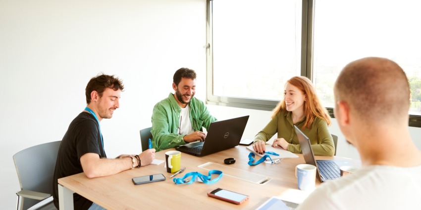 adessi at the desk and smiling adessi at the desk and smiling
