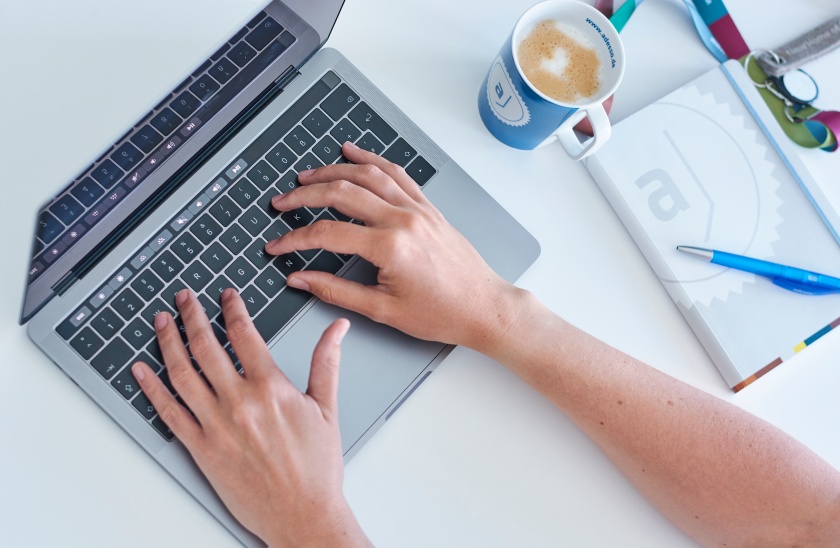 Two handy tyiping on a notebook keyboard