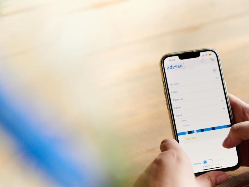 Photo of an iphone with the adesso blog open