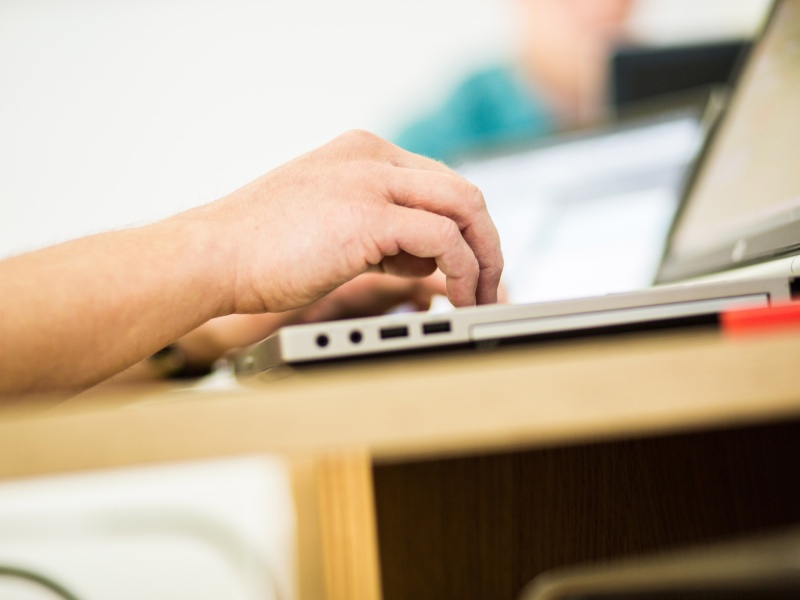 Hands typing on a keyboard